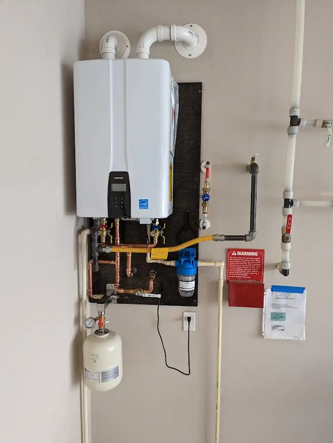 Professional plumber installing copper piping in a Cascades home